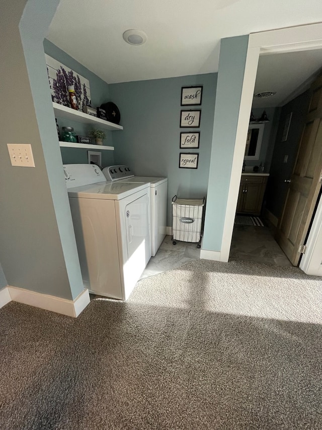 laundry area with washing machine and clothes dryer and carpet flooring