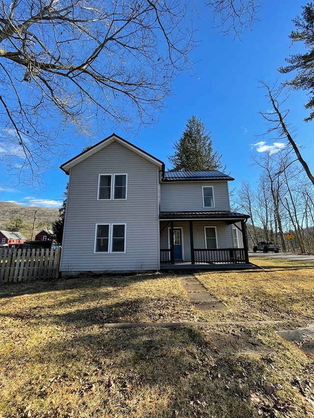 view of front of house featuring covered porch and a front yard