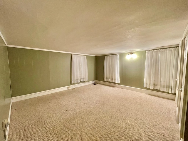 carpeted spare room featuring crown molding and a textured ceiling