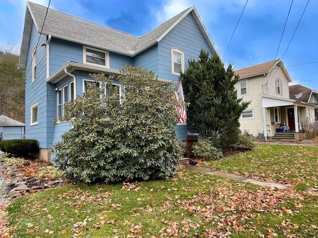 view of side of property with a lawn