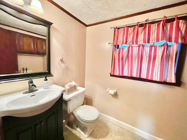 bathroom with vanity, toilet, and crown molding