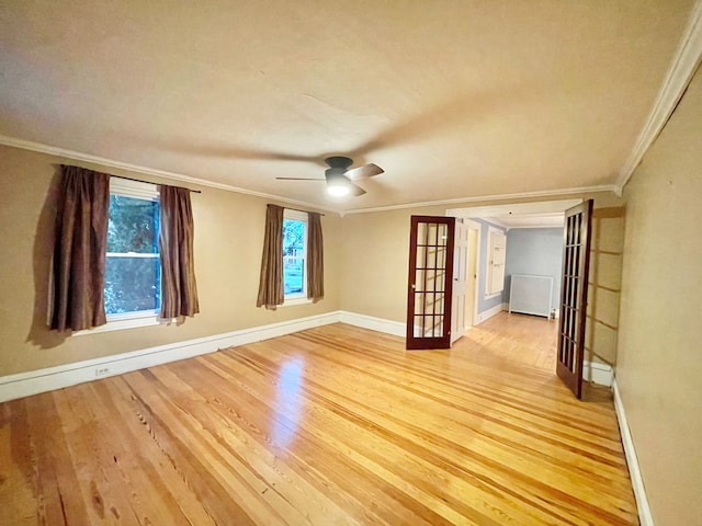 spare room featuring ceiling fan, french doors, light hardwood / wood-style floors, and ornamental molding