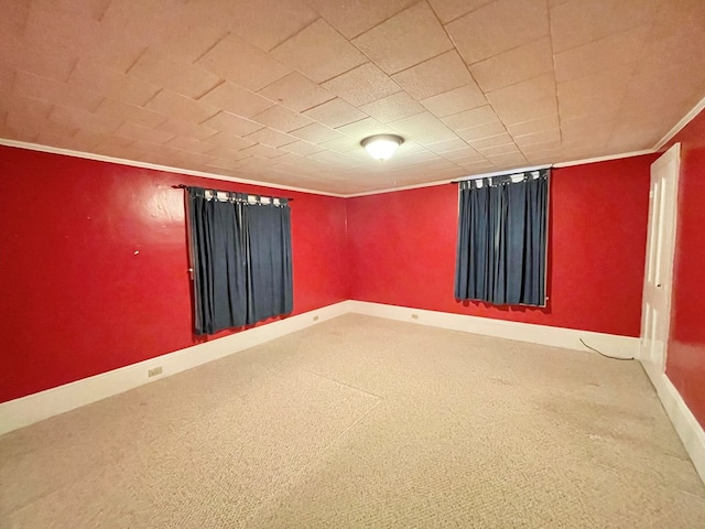 basement with carpet flooring and crown molding