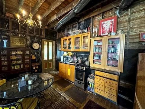 bar with a chandelier, french doors, and gas range