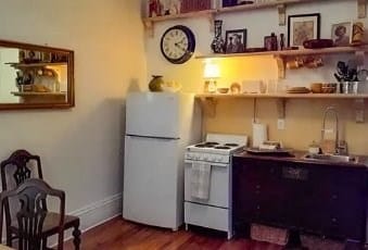 kitchen with dark wood-style floors, open shelves, white appliances, and a sink