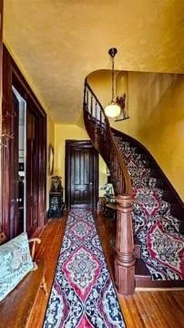 entrance foyer with stairway and wood finished floors