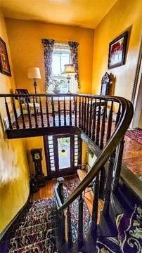 staircase with hardwood / wood-style flooring