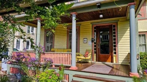 view of exterior entry with covered porch