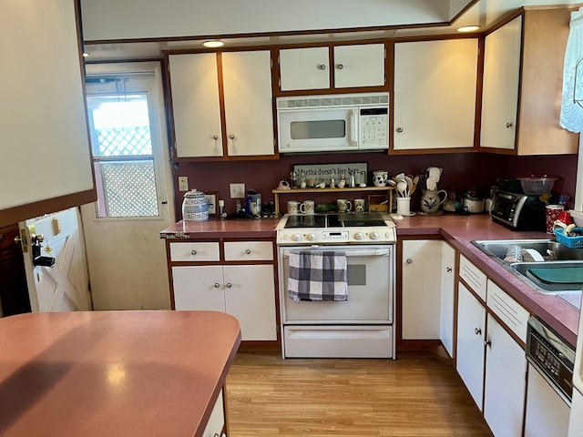 421 State St, Towanda, PA 18848 - kitchen with white appliances, light wood-style flooring, and white cabinetry