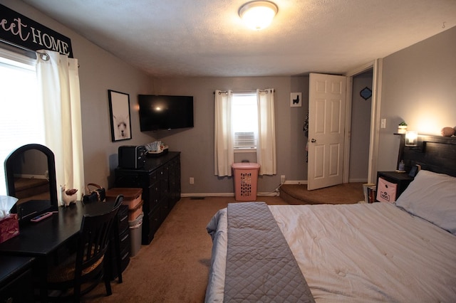 bedroom featuring carpet flooring and a textured ceiling