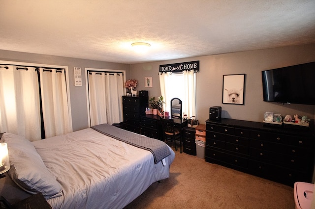 carpeted bedroom featuring a textured ceiling