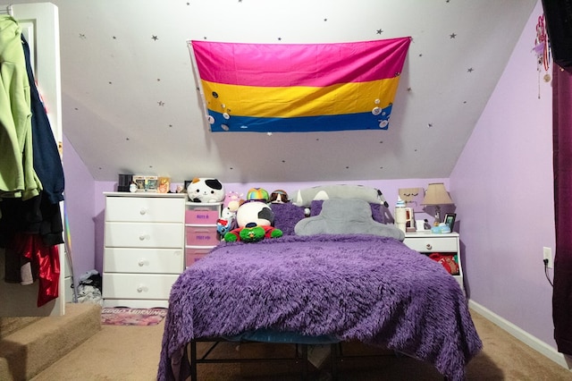 bedroom featuring light colored carpet and lofted ceiling