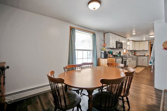 dining area featuring a baseboard radiator and wood-type flooring