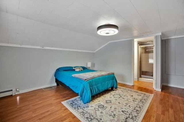 bedroom featuring hardwood / wood-style flooring and lofted ceiling