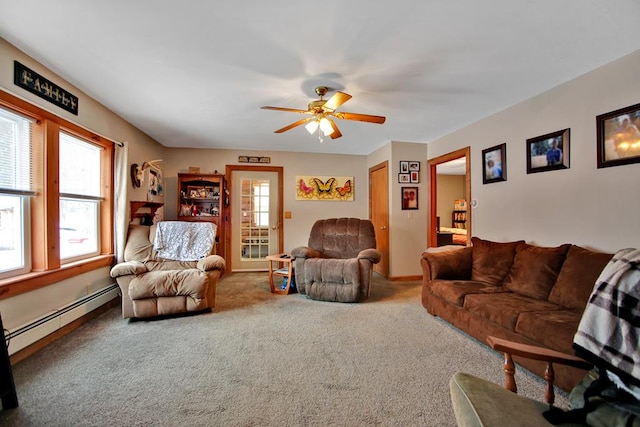 carpeted living room with ceiling fan and a baseboard radiator