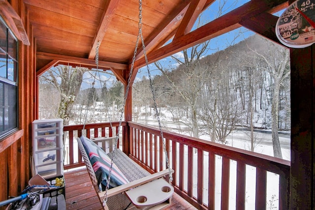 snow covered deck featuring a mountain view