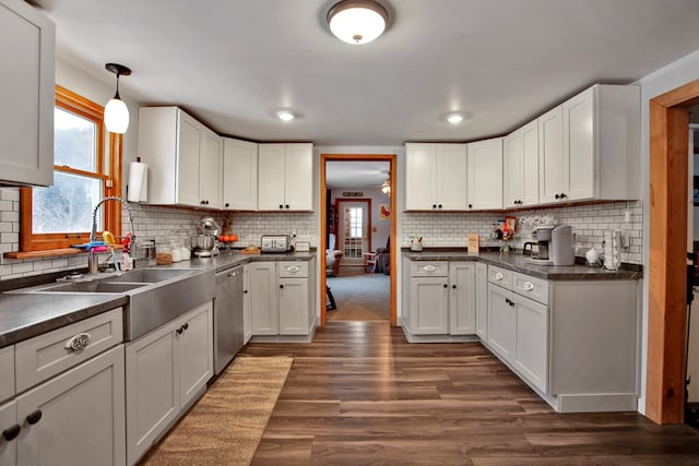 kitchen with white cabinets, hanging light fixtures, and dishwasher