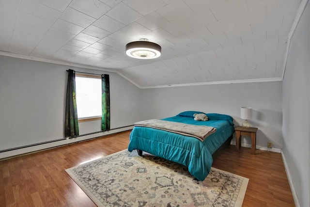 bedroom with hardwood / wood-style floors, crown molding, a baseboard heating unit, and lofted ceiling