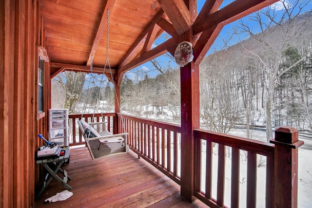 snow covered deck featuring a mountain view