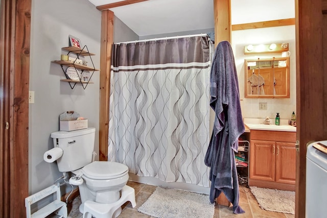 bathroom featuring toilet, vanity, and walk in shower