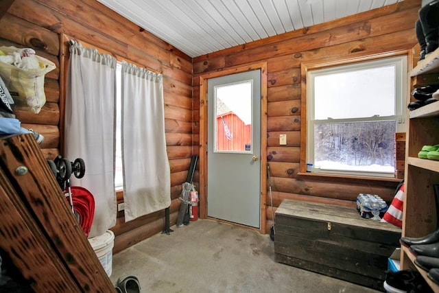 doorway to outside with wood ceiling