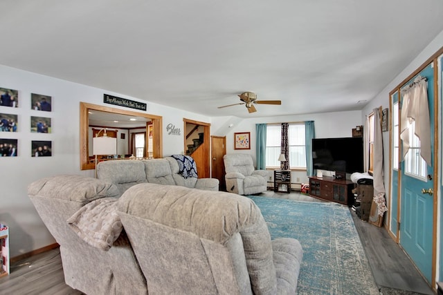 living room featuring light hardwood / wood-style floors and ceiling fan