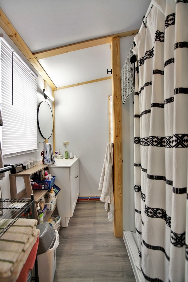 bathroom with curtained shower, vanity, and wood-type flooring