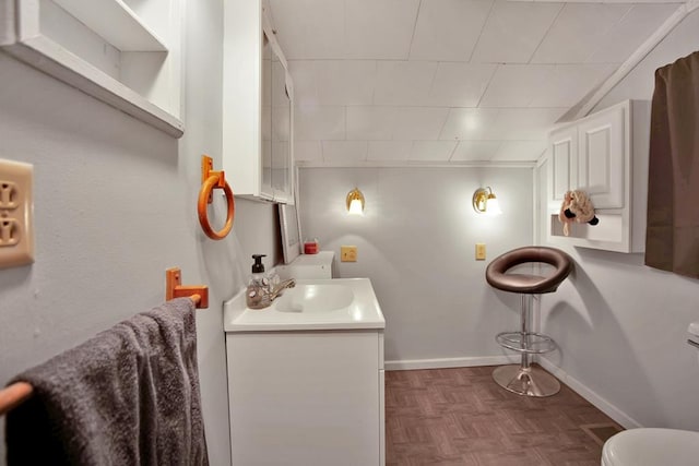 bathroom with vanity and parquet floors