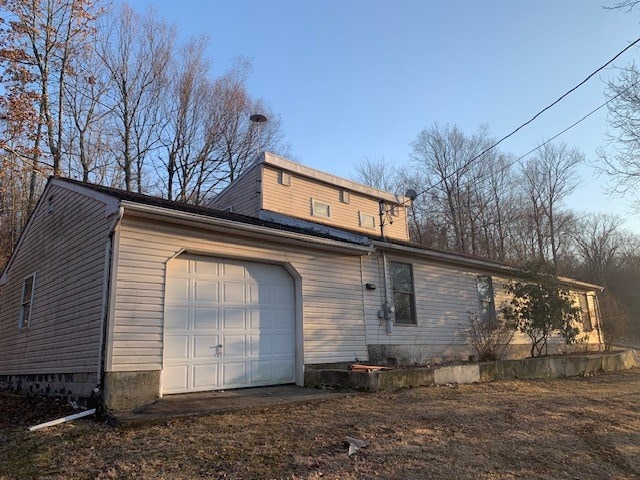 back of house featuring a garage