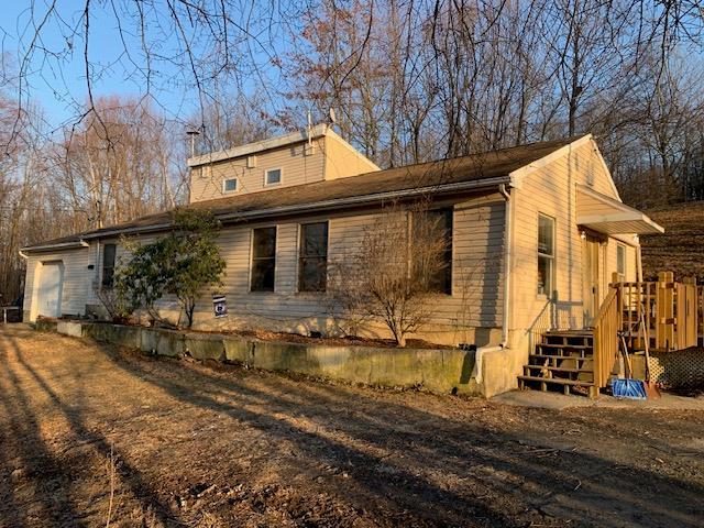 view of side of property featuring an attached garage