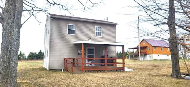 1068 Ridge Rd, Gaines, PA 16921 - rear view of house with a wooden deck and a lawn