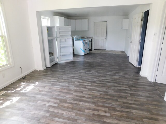 kitchen with white cabinetry, white electric range oven, and dark hardwood / wood-style floors