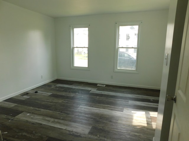 spare room with dark hardwood / wood-style flooring