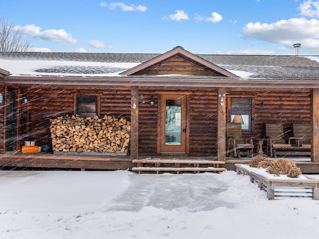 view of snow covered property entrance