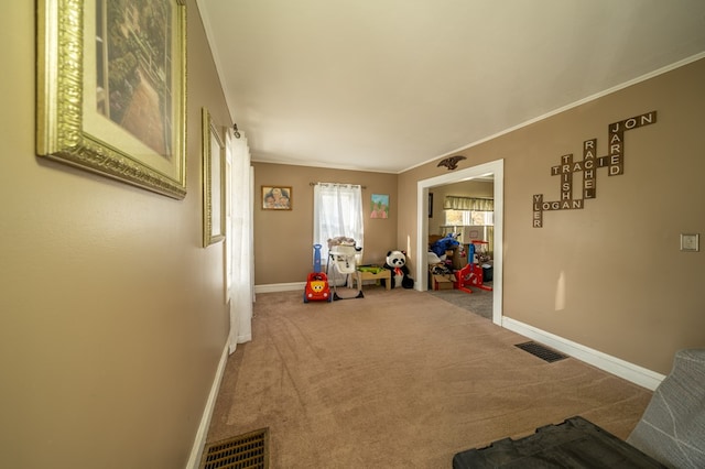 rec room featuring crown molding and carpet floors