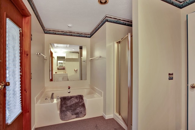 bathroom featuring shower with separate bathtub and a textured ceiling