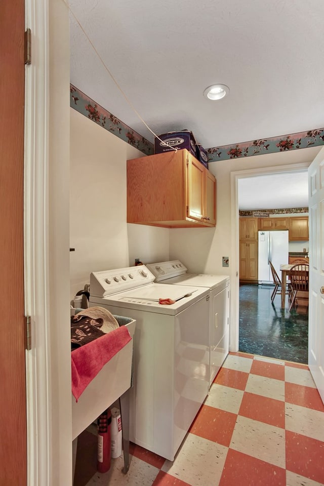 laundry area with cabinets and washer and dryer