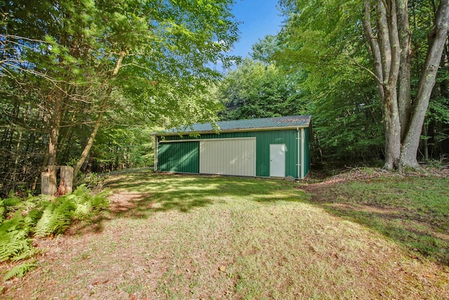 view of outbuilding featuring a lawn