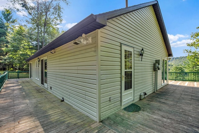 view of home's exterior featuring a wooden deck