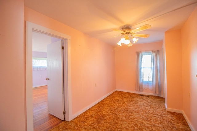 spare room featuring carpet, ceiling fan, and a healthy amount of sunlight