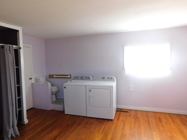 laundry area with washer and clothes dryer and wood-type flooring