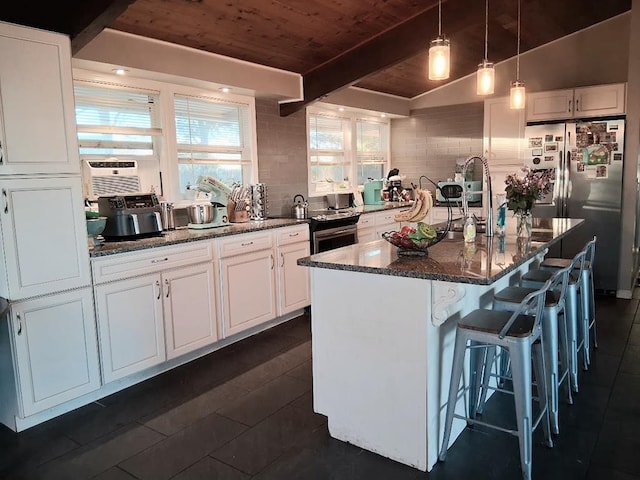 47 Alpine Dr, Athens, PA 18810 - kitchen with wooden ceiling with exposed beams, freestanding refrigerator, white cabinetry, dark stone countertops, and a breakfast bar