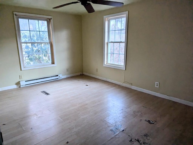 empty room with light wood-type flooring, ceiling fan, and baseboard heating