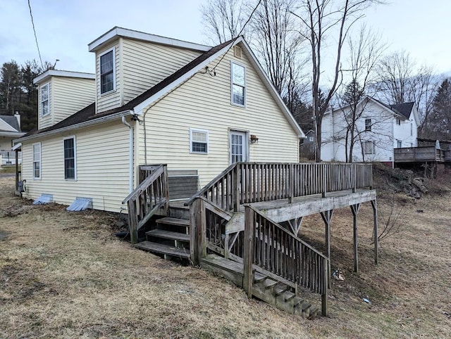 back of house with a wooden deck