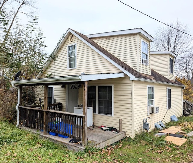 rear view of house featuring cooling unit and a deck