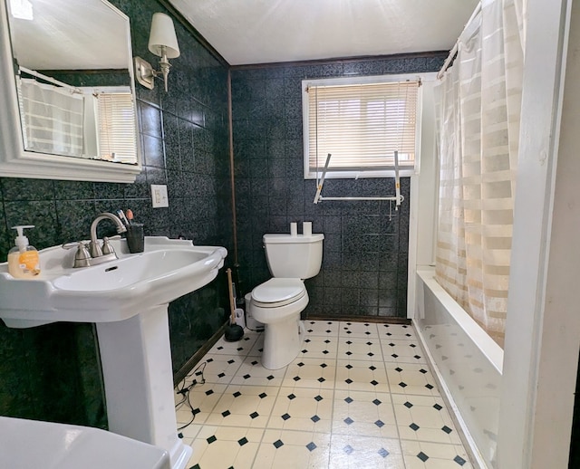 full bathroom featuring tile walls, shower / bath combination with curtain, tile patterned floors, and toilet