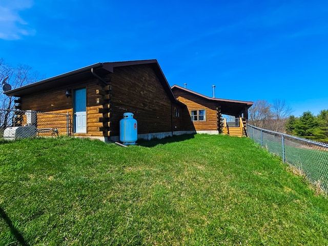 102-108 Fred Catlin Rd, Owego, NY 13827 - view of property exterior with a fenced backyard, log exterior, and a yard