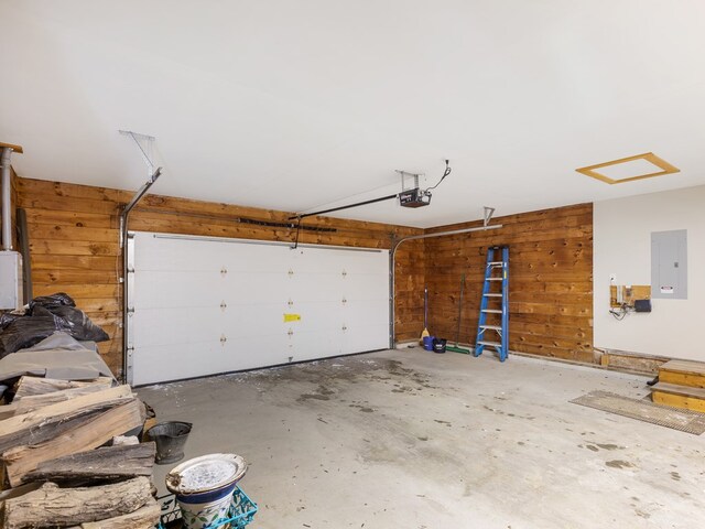 102-108 Fred Catlin Rd, Owego, NY 13827 - garage with wooden walls, a garage door opener, and electric panel
