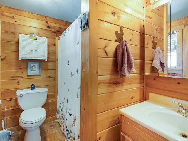 102-108 Fred Catlin Rd, Owego, NY 13827 - full bathroom featuring curtained shower, wood walls, vanity, and toilet