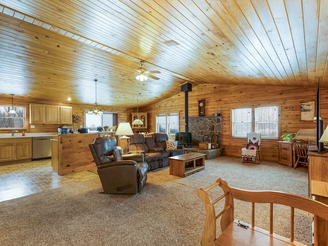 102-108 Fred Catlin Rd, Owego, NY 13827 - living area featuring wooden walls, vaulted ceiling, a wood stove, and a healthy amount of sunlight